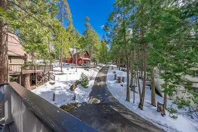 a snow covered road in a yard with trees at Ridgeview Retreat Location Meets Comfort AC! in Shaver Lake