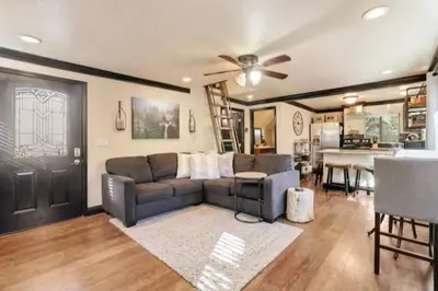 a living room with a couch and a ceiling fan at Hibernation Station Walkable, Warm Well-Loved in Shaver Lake