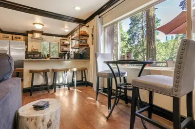 a kitchen and living room with a table and chairs at Hibernation Station Walkable, Warm Well-Loved in Shaver Lake