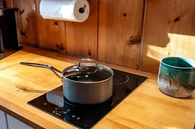 a pot on top of a stove in a kitchen at A-Frame Escape Unique stay w comfort & style in Shaver Lake