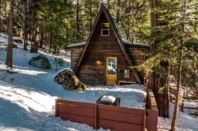 a cabin in the woods in the snow at A-Frame Escape Unique stay w comfort & style in Shaver Lake