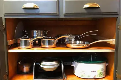 a group of pots and pans on a shelf in a kitchen at The Elderberry Retreat - It's a Dream Location! in Shaver Lake