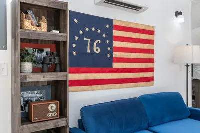 an american flag mural in a living room with a blue couch at Dome Sweet Dome | Shaver Lake in Shaver Lake