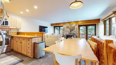 a large kitchen with a wooden table and chairs at Lakeview Villas #09 condo in Mammoth Lakes