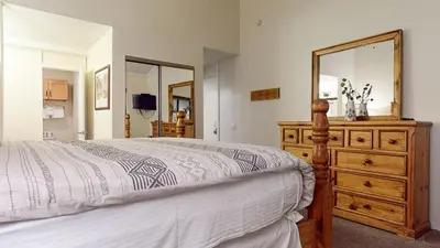 a bedroom with a bed and a dresser with a mirror at Summit #48 condo in Mammoth Lakes