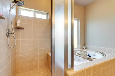 a bathroom with a tub and a shower stall at Clovis Retreat with Patio and Yard about 3 Mi to Old Town! in Clovis