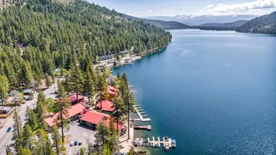 an aerial view of a town on the shore of a lake at Spacious 1br Condo w/Partial Lake View #117 at Donner Lake Village in Truckee