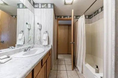 a bathroom with a sink and a shower at Spacious 1br Condo w/Partial Lake View #117 at Donner Lake Village in Truckee