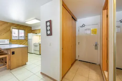 a kitchen with a counter and a door in a room at Spacious 1br Condo w/Partial Lake View #117 at Donner Lake Village in Truckee