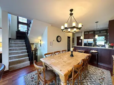 a dining room with a wooden table and chairs at Luxury Townhome w/ Views, Private Jacuzzi & Garage in Mammoth Lakes