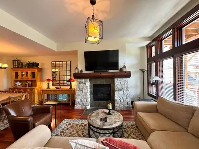 a living room with a couch and a fireplace at Luxury Townhome w/ Views, Private Jacuzzi & Garage in Mammoth Lakes
