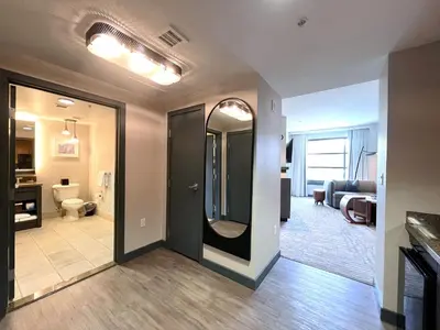 a room with a hallway with a door and a living room at Luxury 2 Bedroom Penthouse with Stunning Views! in Mammoth Lakes