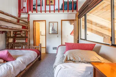 a bedroom with two bunk beds and a ladder at Courchevel #15 - 2 Bedroom, 2 Bathroom, Sleeps 6! Just steps to Canyon Lodge! in Mammoth Lakes