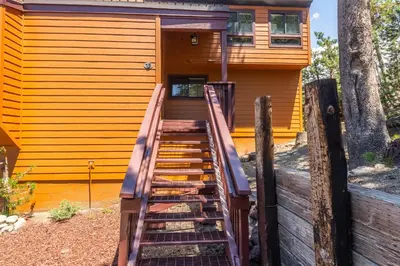 a wooden staircase leading up to a house at Courchevel #15 - 2 Bedroom, 2 Bathroom, Sleeps 6! Just steps to Canyon Lodge! in Mammoth Lakes