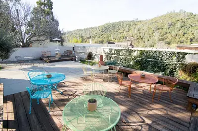 a group of tables and chairs on a patio at River Rock Inn in Mariposa