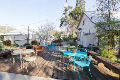 a patio with tables and chairs on a deck at River Rock Inn in Mariposa