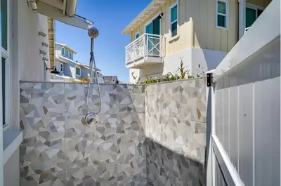 a white fence with a stone wall in front of a building at Waterfront Resort Style Villa - 5 min to fastwater in Oakley