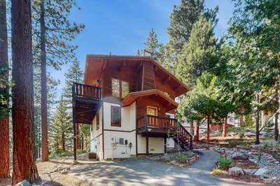 a house in the woods with a balcony at Wild Horse Hideaway in Incline Village