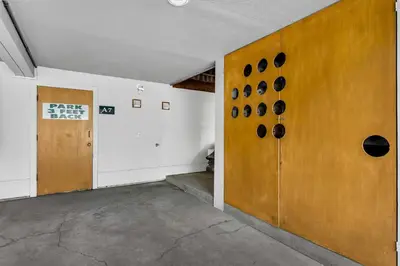 an empty room with a wall with black plates on it at Palisades Condo - Walk to Ski Lift! in Olympic Valley