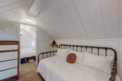 a bedroom with a white bed with a pillow on it at 10 Mi to Bear Valley Resort Serene Mtn Retreat in Tamarack