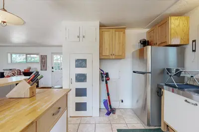 a kitchen with wooden cabinets and a refrigerator at 10 Mi to Bear Valley Resort Serene Mtn Retreat in Tamarack