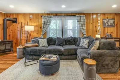 a living room with a couch and a fireplace at California Mountain Cabin with Lake Access and Deck! in Long Barn