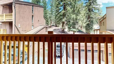 a view of a yard from a balcony of a house at Mammoth Ski & Racquet Club #118 condo in Mammoth Lakes