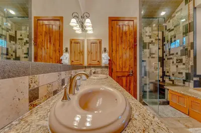 a bathroom with a sink and a shower at Lakefront Retreat Across from Homewood Resort in Homewood