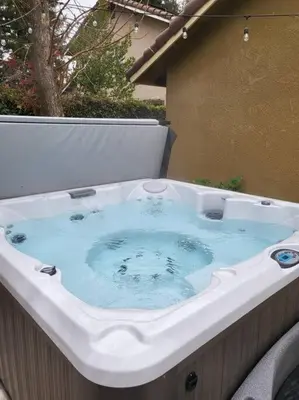 a jacuzzi tub in a backyard at 3 Bedrooms,Beautiful House with Hot Tub, Pool Oasis and Fire Pit in Clovis