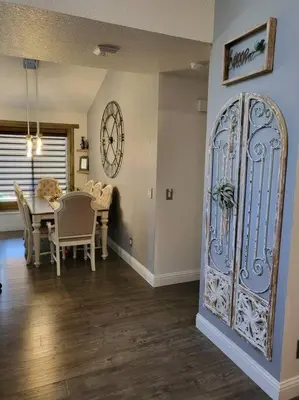 a dining room with a table and a large door at 3 Bedrooms,Beautiful House with Hot Tub, Pool Oasis and Fire Pit in Clovis