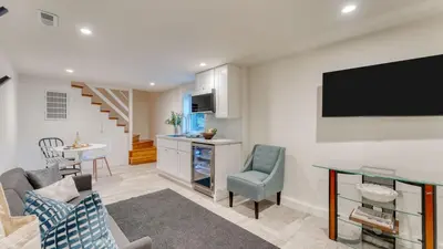 a living room with a tv on a wall at West Shore Lake House by AvantStay Ski Cabin w Backyard Sledding Hill in Homewood