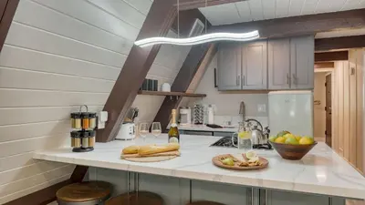 a kitchen with a counter with a plate of food at Speckled by AvantStay Modern Interior 0.5mi to Lake in Kings Beach