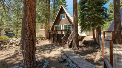 a cabin in the woods with trees at Speckled by AvantStay Modern Interior 0.5mi to Lake in Kings Beach