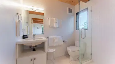 a bathroom with a sink and a toilet and a shower at Trapper by AvantStay A Interior Design w Sauna in Alpine Meadows