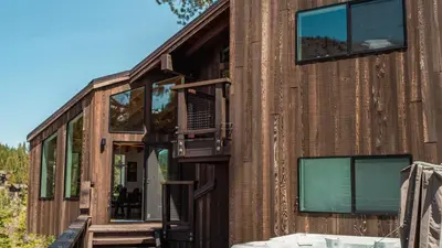 a house made out of wood with the door open at Trapper by AvantStay A Interior Design w Sauna in Alpine Meadows