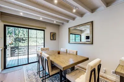 a dining room with a wooden table and chairs at Modern Mountain Getaway in Olympic Valley