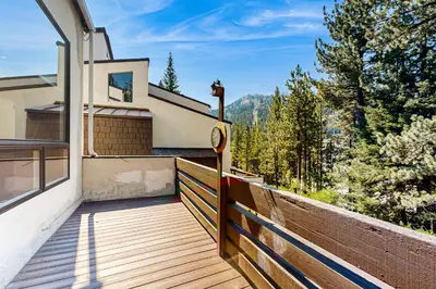a balcony of a house with a view of the mountains at Modern Mountain Getaway in Olympic Valley