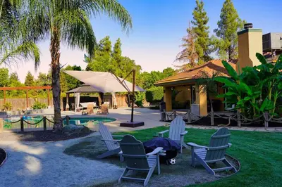 a yard with a group of chairs and a pool at Fernwood Retreat at Madera Ranchos in Madera