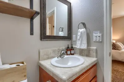 a bathroom with a sink and a mirror at Yosemite Hilltop Gated Villa near Oakhurst, Bass Lake and Mariposa w EVCharger Hottub Grill and Awesome Views! in Ahwahnee