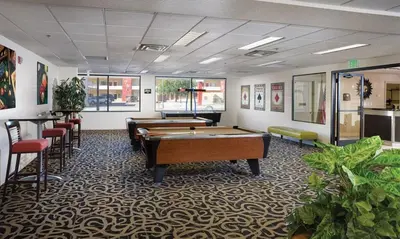 a room with two pool tables and some chairs at Great 1BD condo with resort amenities take in all Reno has to offer in Reno