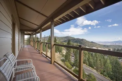 a balcony with white chairs and a view of the mountains at Worldmark Lake Tahoe - 1BD Sleeps up to 4 in Stateline