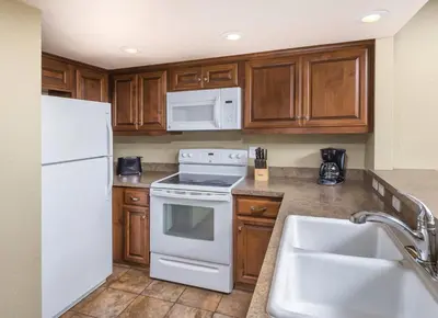 a kitchen with white appliances and wooden cabinets at Worldmark Lake Tahoe - 1BD Sleeps up to 4 in Stateline