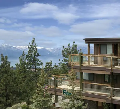 a building with a balcony with mountains in the background at Worldmark Lake Tahoe - 2BD Sleeps up to 6 in Stateline