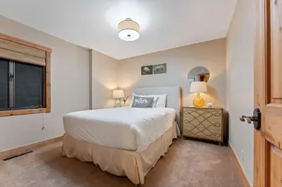 a bedroom with a large bed and a window at Alpine Meadows Retreat 3 Min to Base with Hot Tub in Alpine Meadows