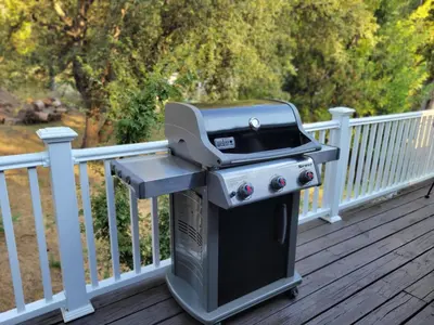 a grill sitting on a deck on a porch at -Serendipity Lodge at Yosemite- BBQ-Full Kitchen-King Bed in Oakhurst
