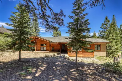 a log cabin with trees in front of it at Compass Luxury Lodge - Access to HOA and Free Shuttle! in Truckee