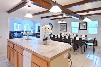 a kitchen and dining room with a large island in a living room at The Valley View- Pine Mountain Lake Cabin home in Groveland