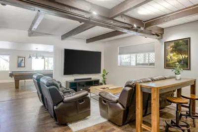 a living room with a table and chairs and a television at The Valley View- Pine Mountain Lake Cabin home in Groveland