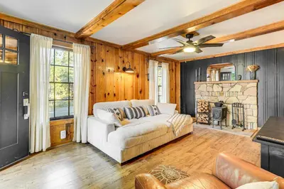 a living room with a couch and a fireplace at Hike, Ski and Fish Charming Cabin in Twain Harte! in Twain Harte