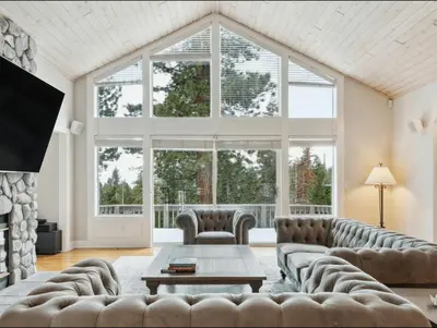 a living room with a large window and a couch at The Royal Canterbury Retreat - Near Kings Beach & Lake Tahoe in Kings Beach